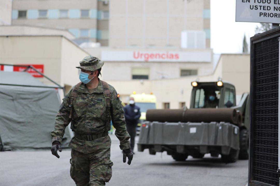 Un soldado pasa junto al área donde militares del Mando de Ingenieros de Salamanca del Ejército de Tierra instalan un hospital provisional en Madrid