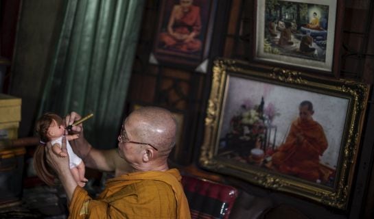 Buddhist monk Phra Winai Thidtapanyo, 64, anoints on a &quot;child angel&quot; doll during a blessing ritual at Wat Bua Khwan temple in Nonthaburi, Thailand, January 26, 2016. A craze for lifelike dolls thought to bring good luck is sweeping Thailand, reflecting wi