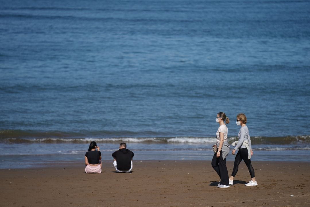 Varias personas pasean por la Playa de Ereaga en Getxo este lunes