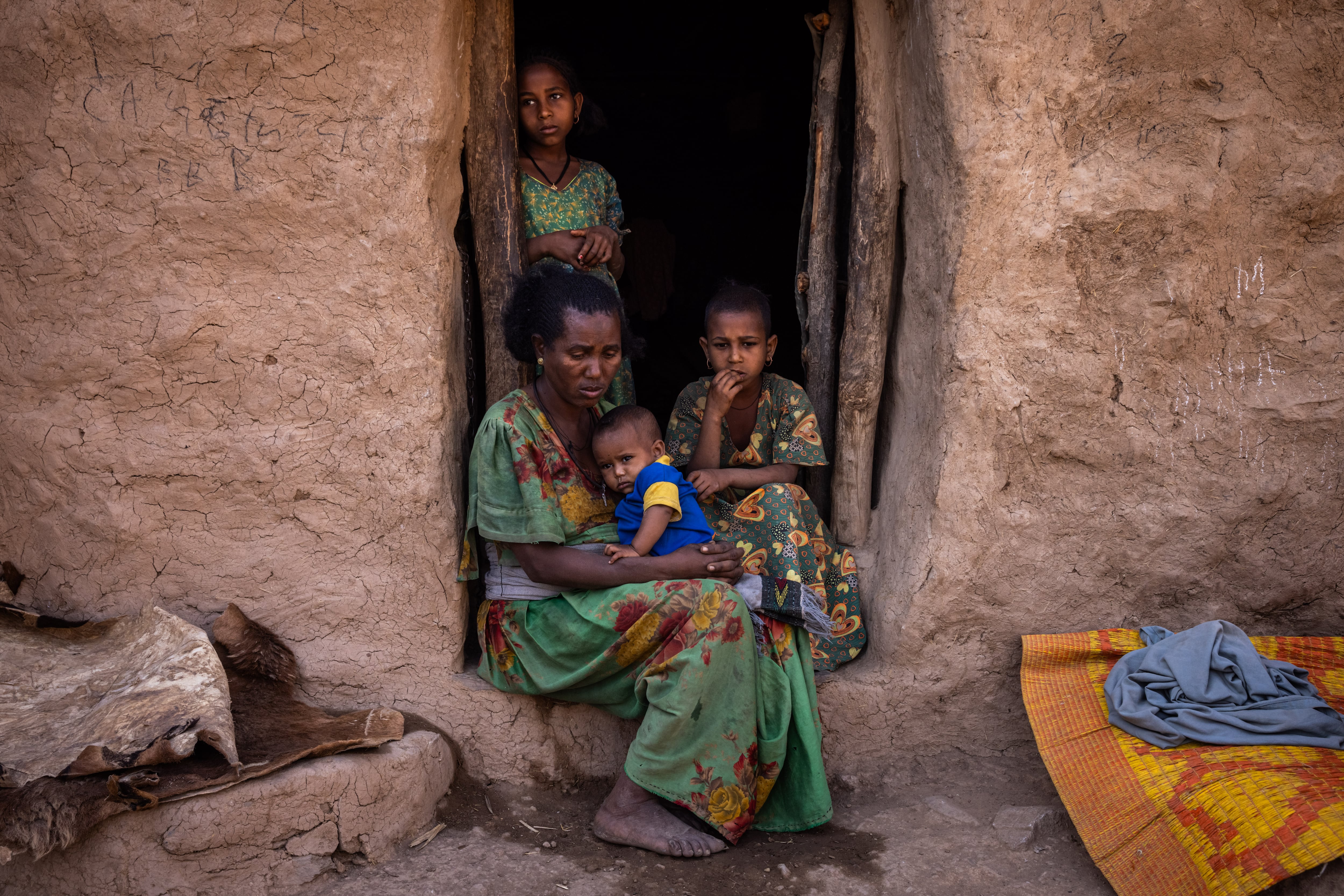 TIGRAY, ETHIOPIA - FEBRUARY 19: Farmer Haile Meruts&#039;s wife sits with her grandchildren in Yechila district on February 19, 2024 in Tigray Region, Ethiopia. More than 20 million Ethiopians are in need of food aid, according to estimates from the UN&#039;s Office for the Coordination of Humanitarian Affairs (UNOCHA). The situation is particularly acute in drought-stricken Tigray, in the country&#039;s north, which is still recovering from a two-year war between the Ethiopian government and allied forces on one side, and Tigrayan forces on the other, during which the region&#039;s economy was devastated and many were displaced. The combined effects of war and drought have raised the specter of famine, which the federal government in Addis Ababa denies is imminent, saying it is committed to providing aid. (Photo by Ed Ram/Getty Images)