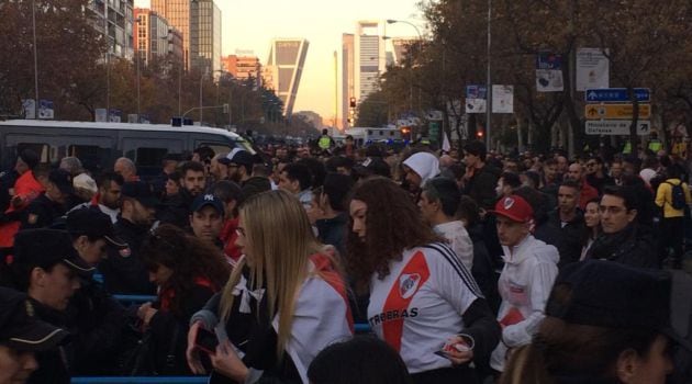 Aficionados de River Plate enseñan sus entradas para poder entrar en los aledaños del partido