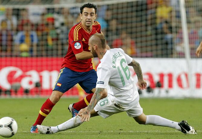 El centrocampista de la selección española Xavi Hernández pelea un balón con el centrocampista de Portugal Raúl Meireles, correspondiente a la primera semifinal de la Eurocopa 2012, esta noche en el estadio Donbass Arena de Donetsk