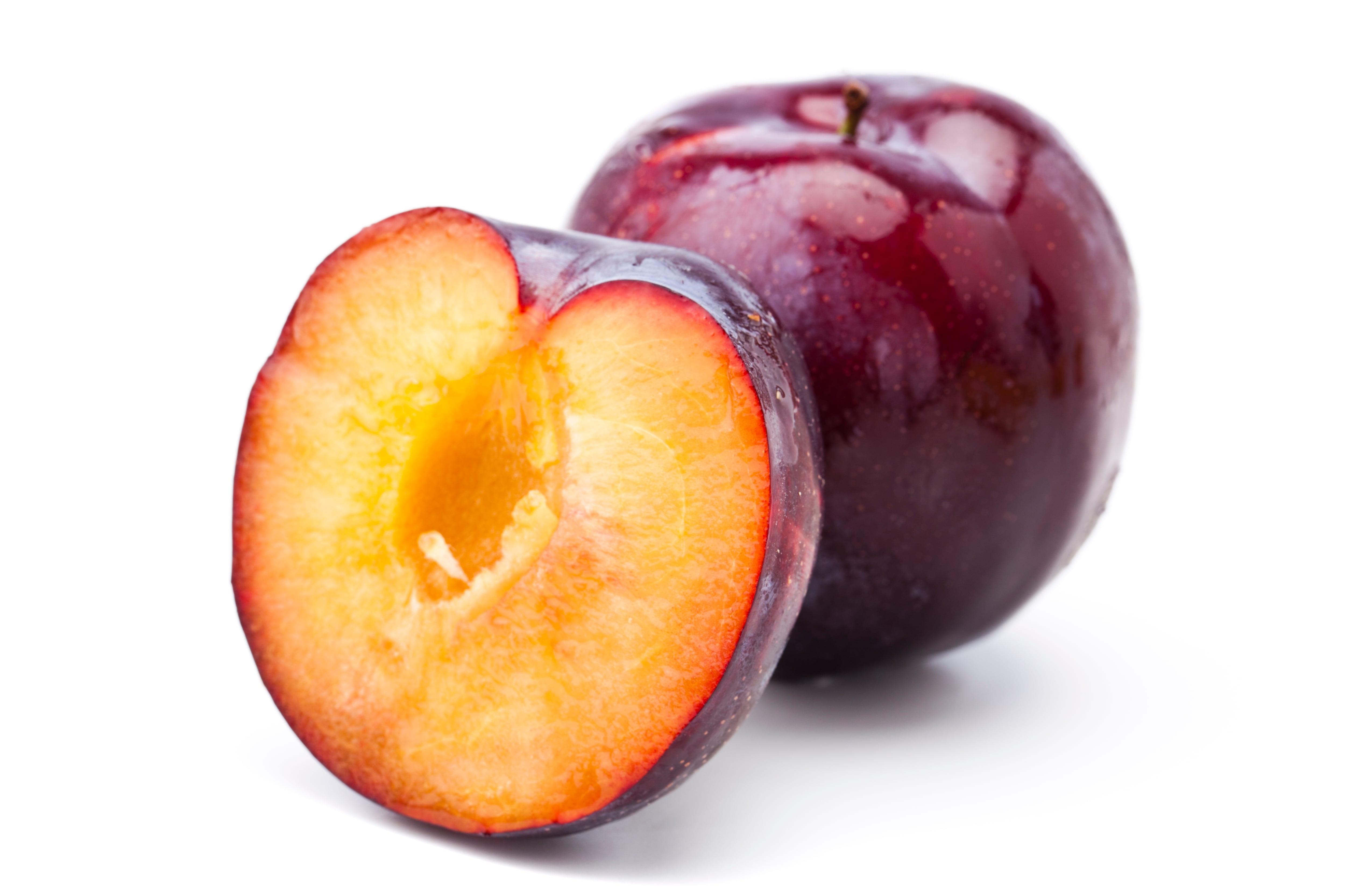 Red plums on white background