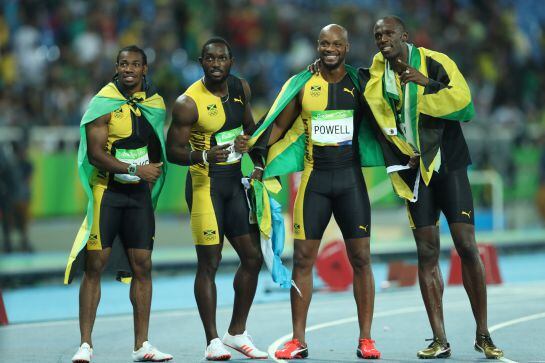 RIO DE JANEIRO, BRAZIL - AUGUST 19: Usain Bolt of Jamaica celebrates with teammates Asafa Powell, Yohan Blake and Nickel Ashmeade after winning the Men&#039;s 4 x 100m Relay Final on Day 14 of the Rio 2016 Olympic Games at the Olympic Stadium on August 19, 201