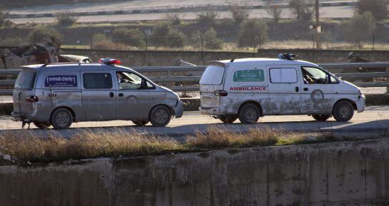 FOTOGALERÍA | Dos ambulancias transportan heridos durante la evacuación de los combatientes, sus familiares y civiles que se encuentran en los barrios rebeldes en Alepo.