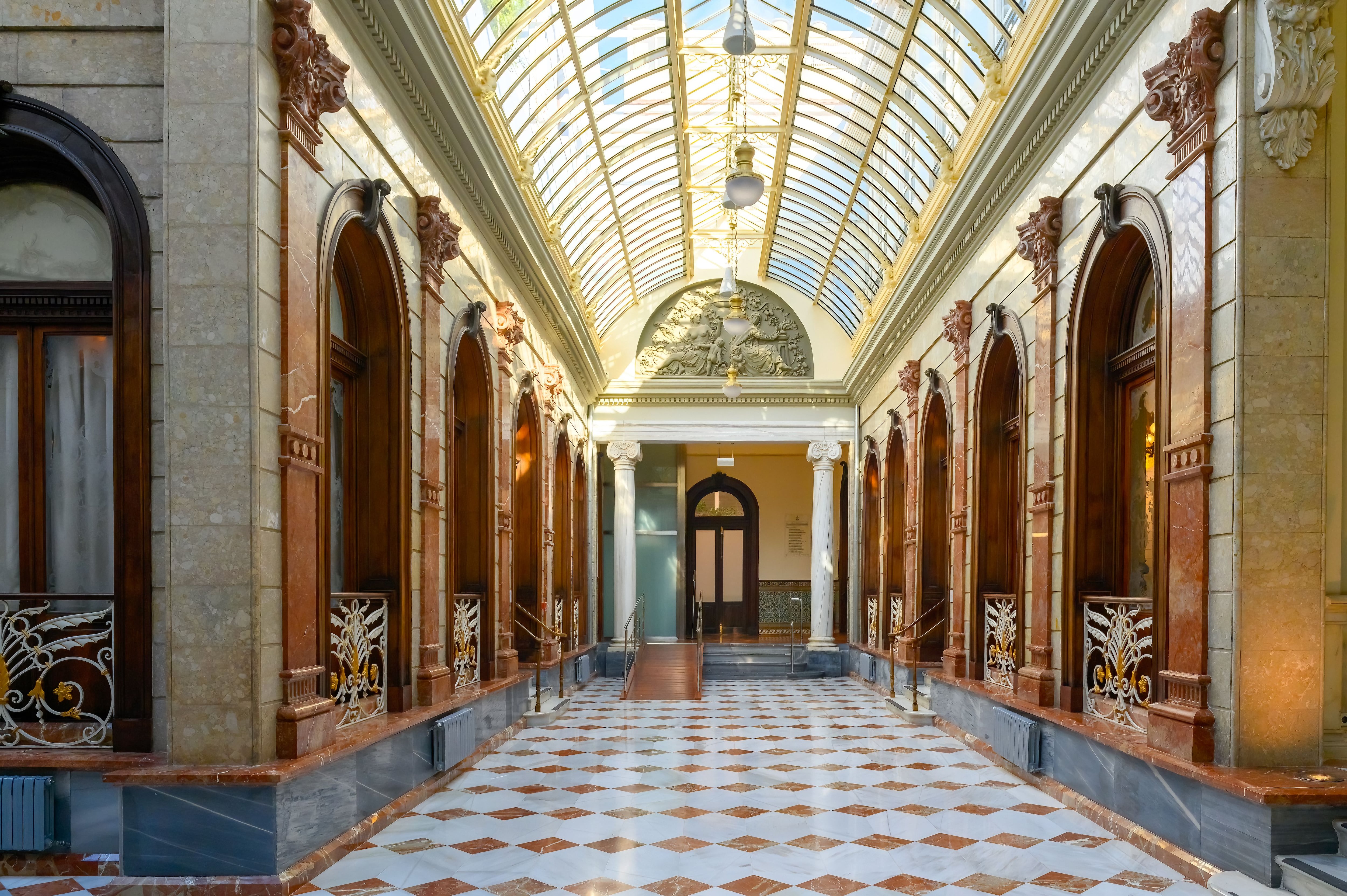 Casino of Murcia, Spain. Symmetry view of the interior courtyard or backyard. Tiled flooring, marble columns, and glass skylight are part of the structures. (Photo by: Roberto Machado Noa/UCG/Universal Images Group via Getty Images)