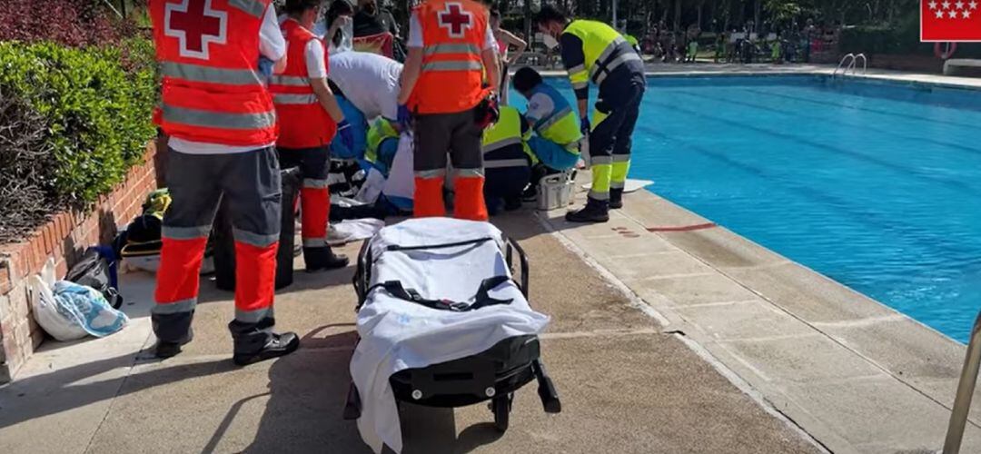 Los sanitarios atendiendo al hombre ahogado junto a la piscina