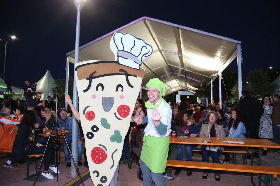 Un pizzero y Pizzi, la mascota del Festival, junto a la carpa central 