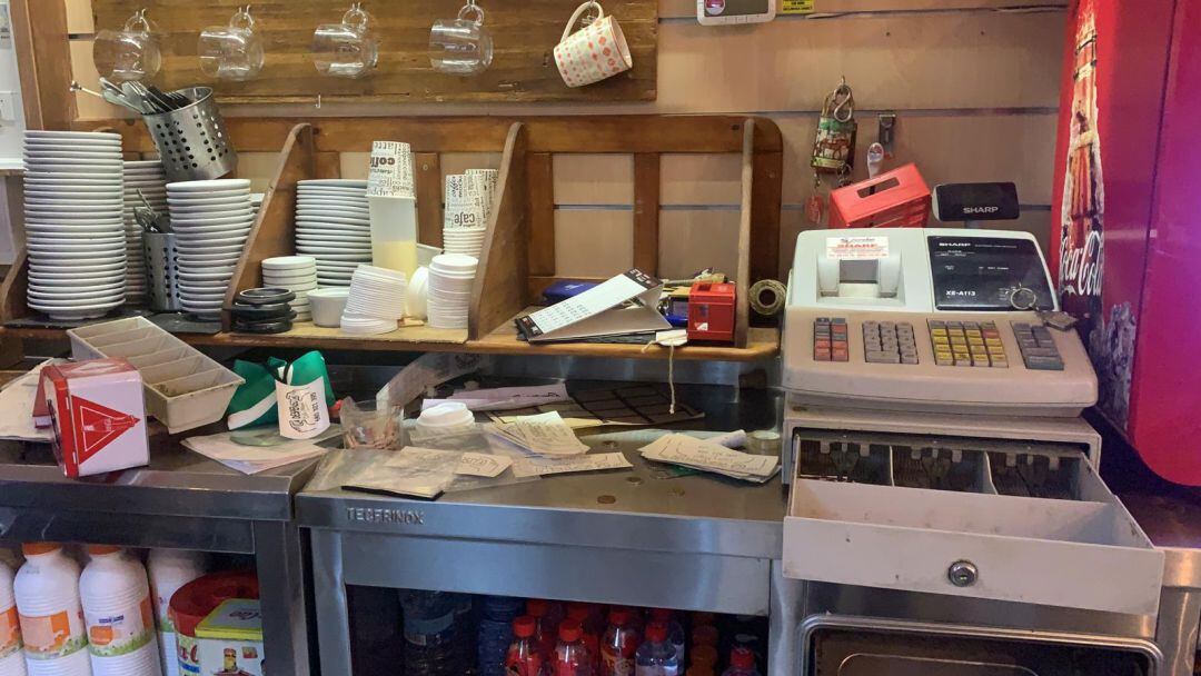 Objetos revueltos y la caja registradora forzada para robar el dinero.