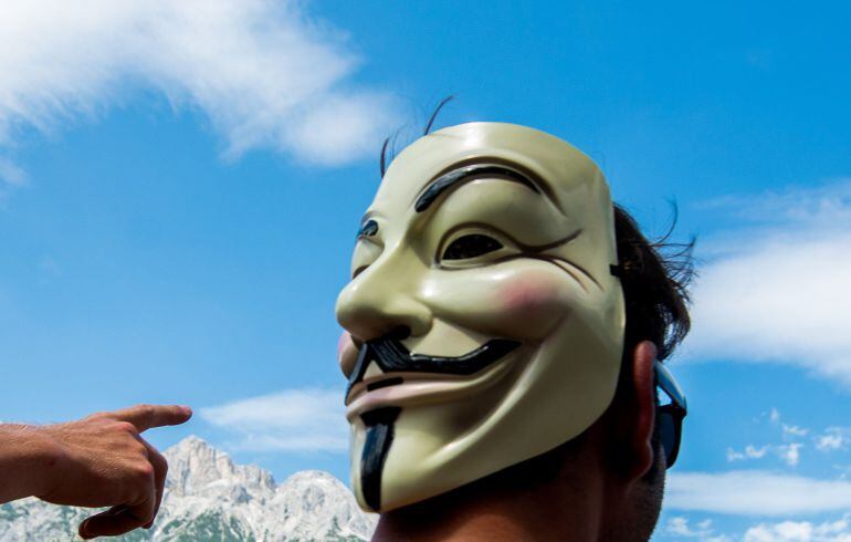 A man wears a Guy Fawkes mask during a demonstration against the Bilderberg conference in Telfs, Austria, on June 13, 2015. The Bilderberg group, which brings together international leaders from politics, high finance, business and academia holds its high