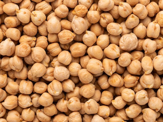 Background of chick-peas macro photo top view, full frame food background