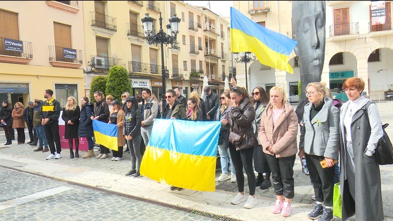 Ciudadanos ucranianos refugiados en nuestra comarca emocionados durante los cinco minutos de silencio a las puertas del Ayuntamiento de Gandia.
