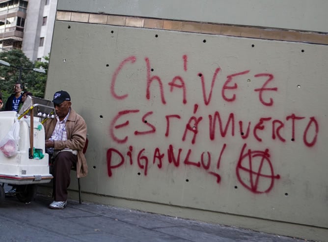 Un hombre vende helados cerca de un graffiti que especula con la muerte del presidente de Venezuela, Hugo Chávez, en Caracas (Venezuela). El grafiti anuncia: &quot;Chávez está muerto, diganlo!&quot;