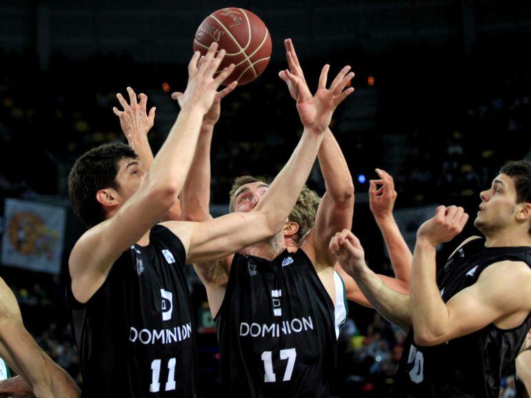 GRA491. BILBAO, 24/05/2015.- Los jugadores del Dominion Bilbao Basket el serbio Marko Todorovic (2i), Axel Hervelle y Dejan Todorovic (d) luchan por el balón con el pívot del Unicaja Vladimir Golubovic (i), durante el partido de la trigésimo cuarta jornada de Liga que disputan en el Bilbao Arena. EFE/LUIS TEJIDO.