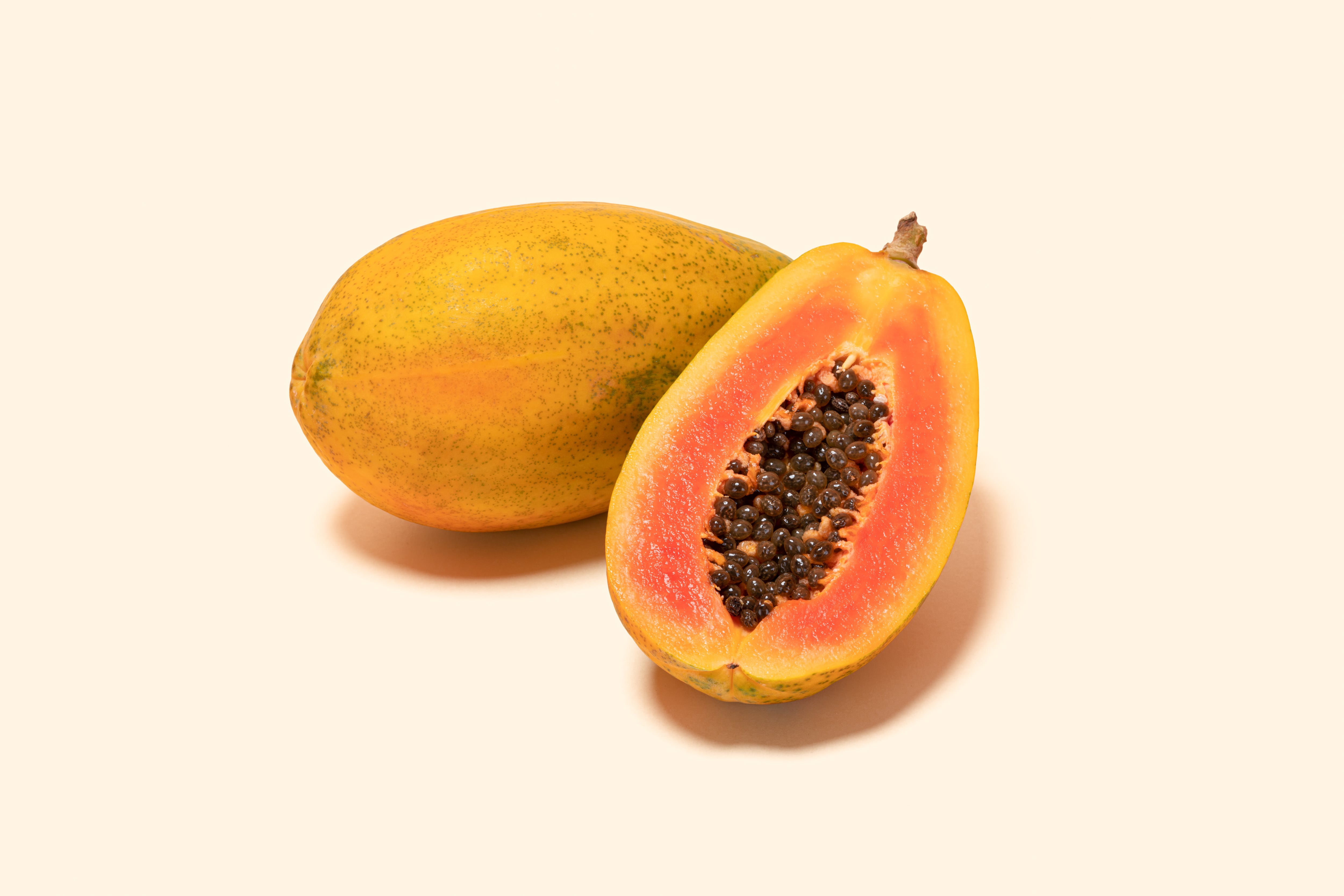 Papaya and Cross Section on Soild Pastle Yellow Colored Background, Clipping Path.