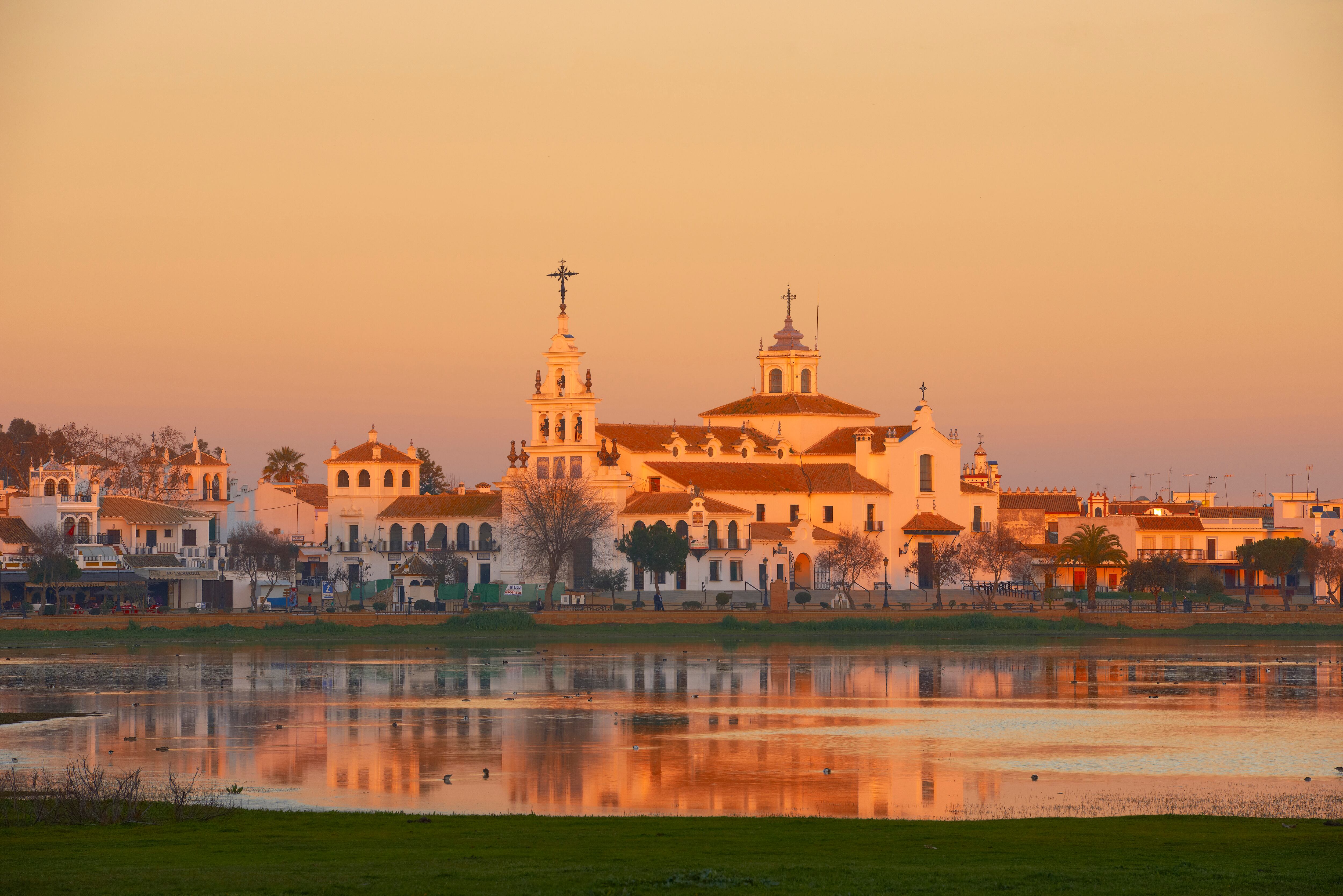 El Rocio village and Hermitage at Sunset, Almonte El Rocio, El Rocío Marismas de Donana, Donana National Park, Huelva province, Andalusia Spain. (Photo by: Education Images/Universal Images Group via Getty Images)