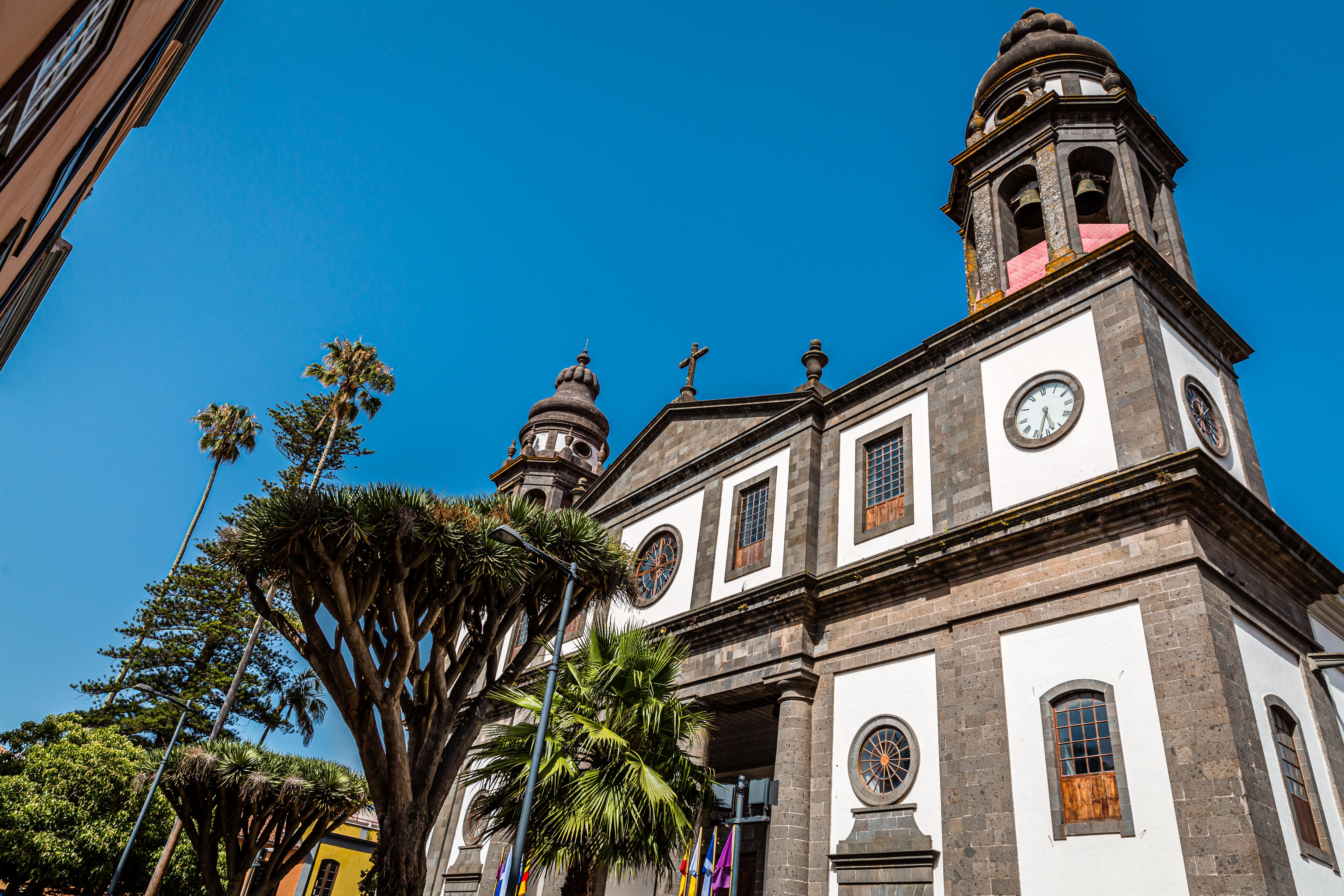 Picture taken in broad daylight by a sunny day in front of the Cathedral of San Cristobal de La Laguna, San Cristóbal de La Laguna, Tenerife, Spain.The Santa Iglesia Catedral de San Cristóbal de La Laguna or Santa Iglesia Catedral de Nuestra Señora de Los Remedios, in the city of San Cristóbal de La Laguna, on the island of Tenerife (Canary Islands, Spain), is a neo-Gothic cathedral in its main body and neoclassical on the façade, headquarters of the Diocese of San Cristóbal de La Laguna (better known as the Diocese of Tenerife), dependent on the Archdiocese of Seville. It is therefore where the episcopal seat of the bishop of this diocese is located.
The most representative elements of the Cathedral of La Laguna are: the neoclassical façade, which is inspired by that of the Cathedral of Pamplona, and the dome, which stands out greatly in the city landscape.
San Cristóbal de La Laguna is a city and municipality in the province of Santa Cruz de Tenerife, on the island of Tenerife, Canary Islands, Spain.