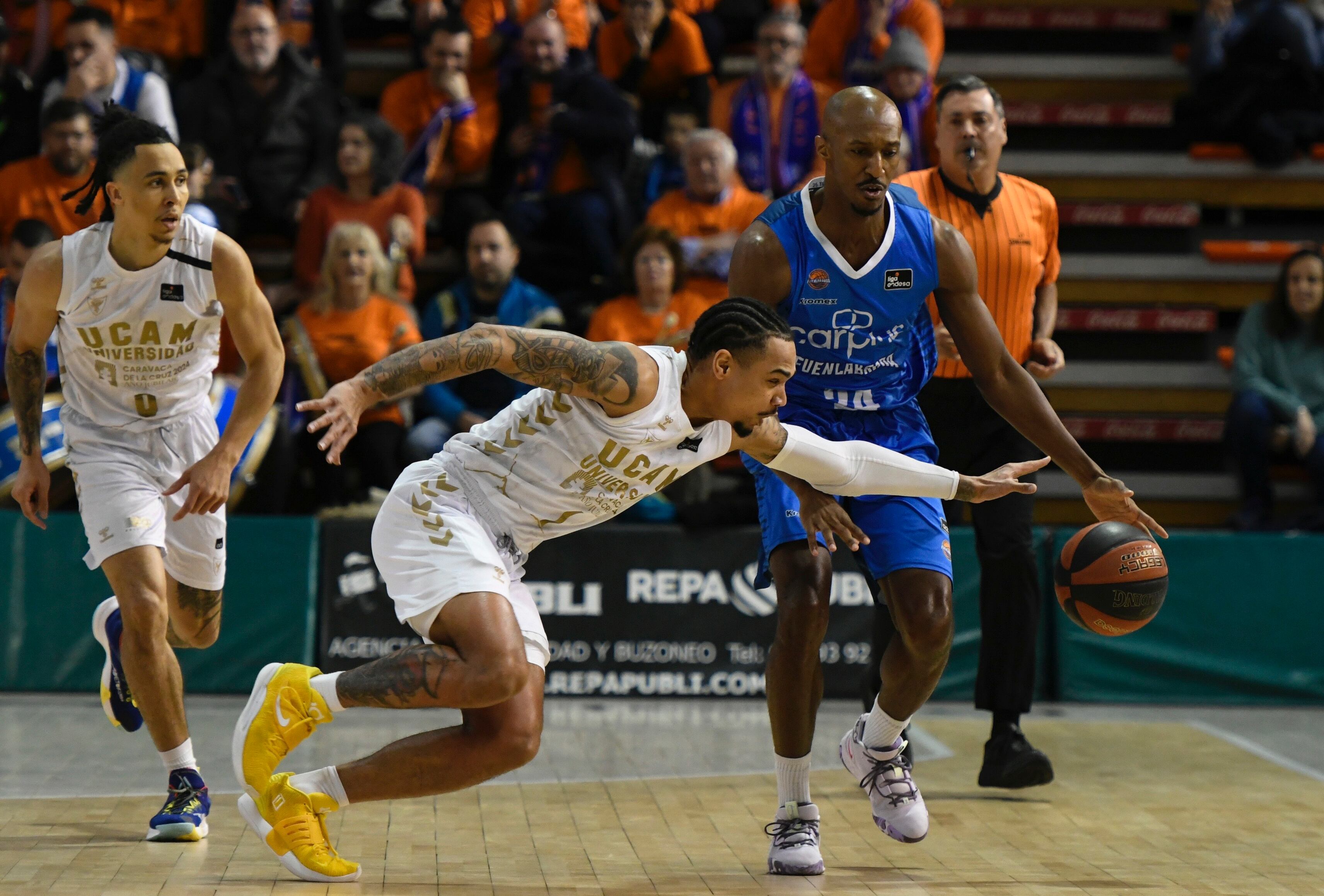 FUENLABRADA (MADRID), 21/01/2023.- El alero del Fuenlabrada Lasan Kromah (d) juega un balón ante Jordan Davis (c), del Murcia, durante el partido de la Liga Endesa de baloncesto entre Corplus Fuenlabrada y UCAM Murcia disputado este sábado en el pabellón Fernando Martín. EFE/Víctor Lerena
