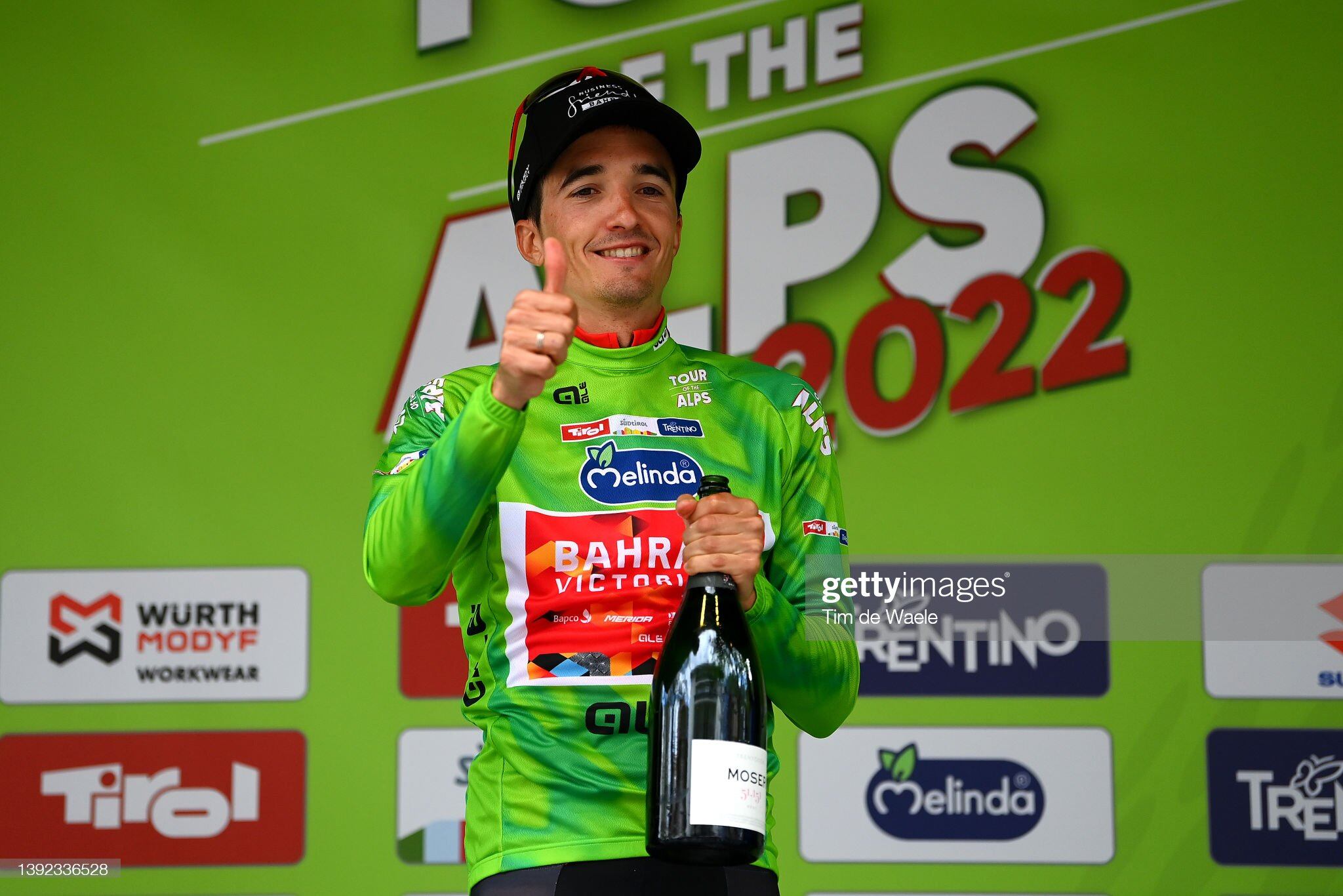 BOLZANO - LANA, ITALY - APRIL 19: Pello Bilbao López De Armentia of Spain and Team Bahrain Victorious celebrates with champagne at podium as Green Leader Jersey winner during the 45th Tour of the Alps 2022 - Stage 2 a 154,1km stage from Primiero/S. Martino di Castrozza to Lana / #TouroftheAlps / on April 19, 2022 in Bolzano - Lana , Italy. (Photo by Tim de Waele/Getty Images)