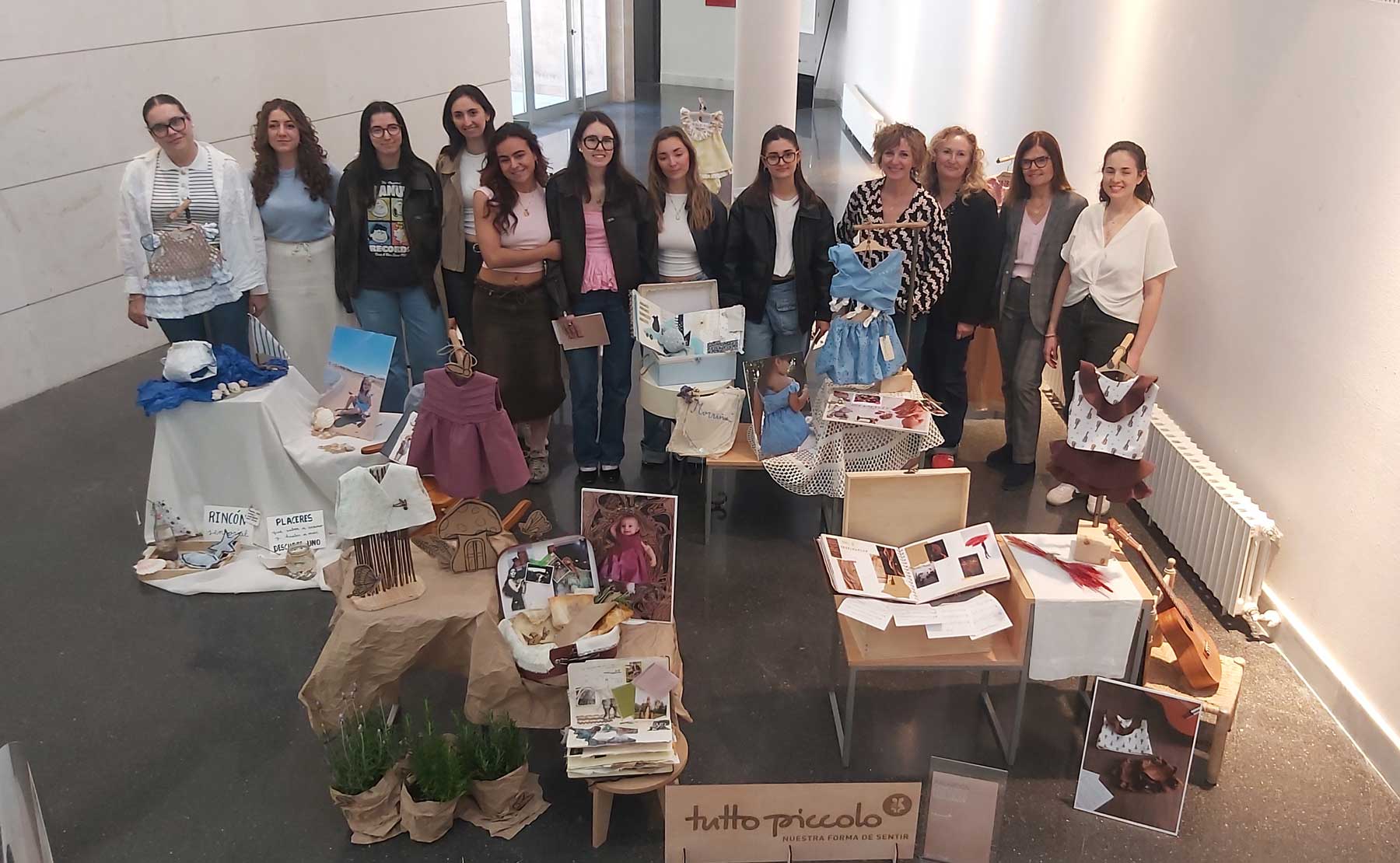 Alumnas participantes, profesoras y jurado, en una foto de familia junto a los diseños presentados