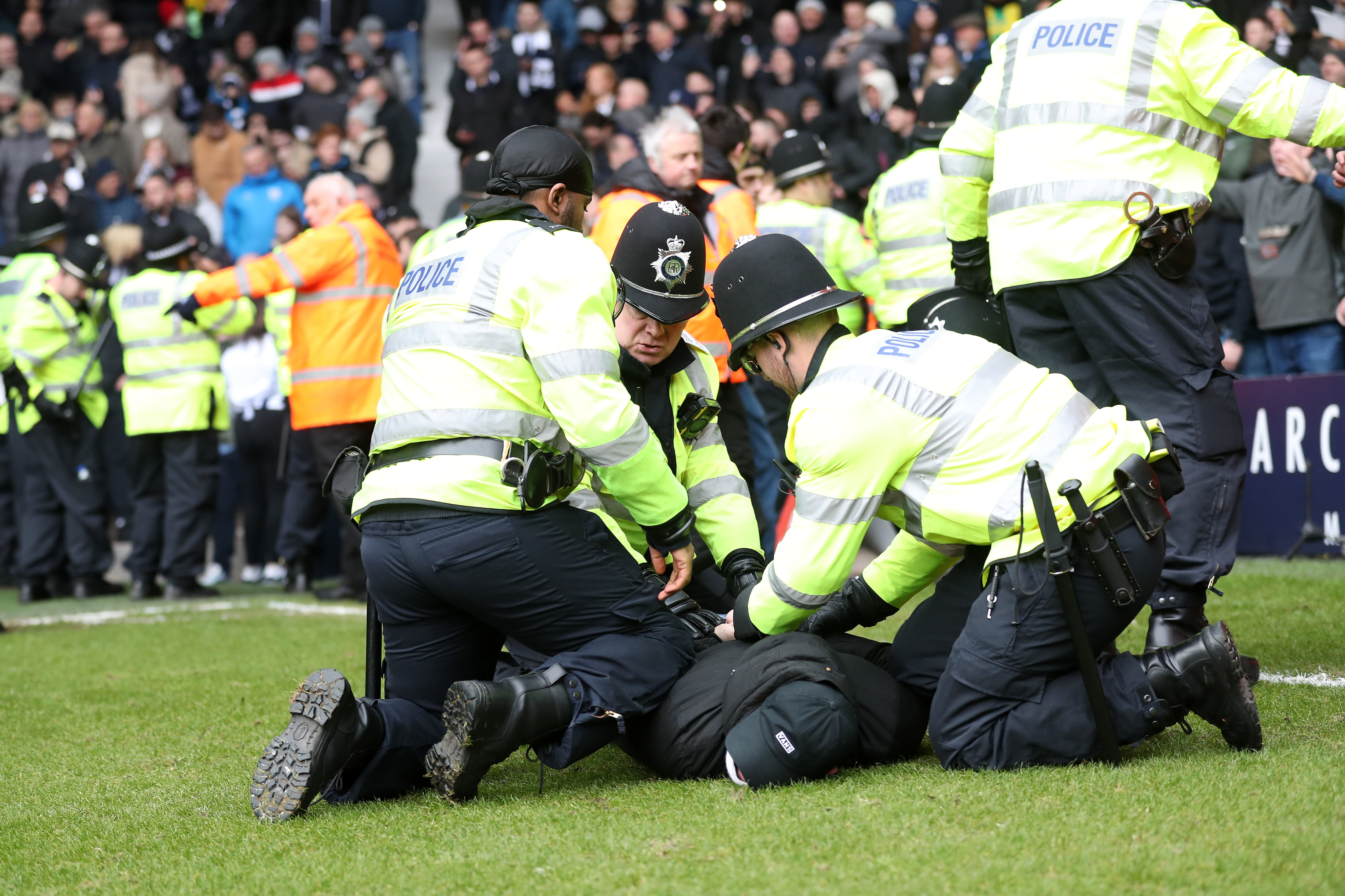 Un aficionado es reducido por la policía durante el West Bromwich Albion - Wolverhampton