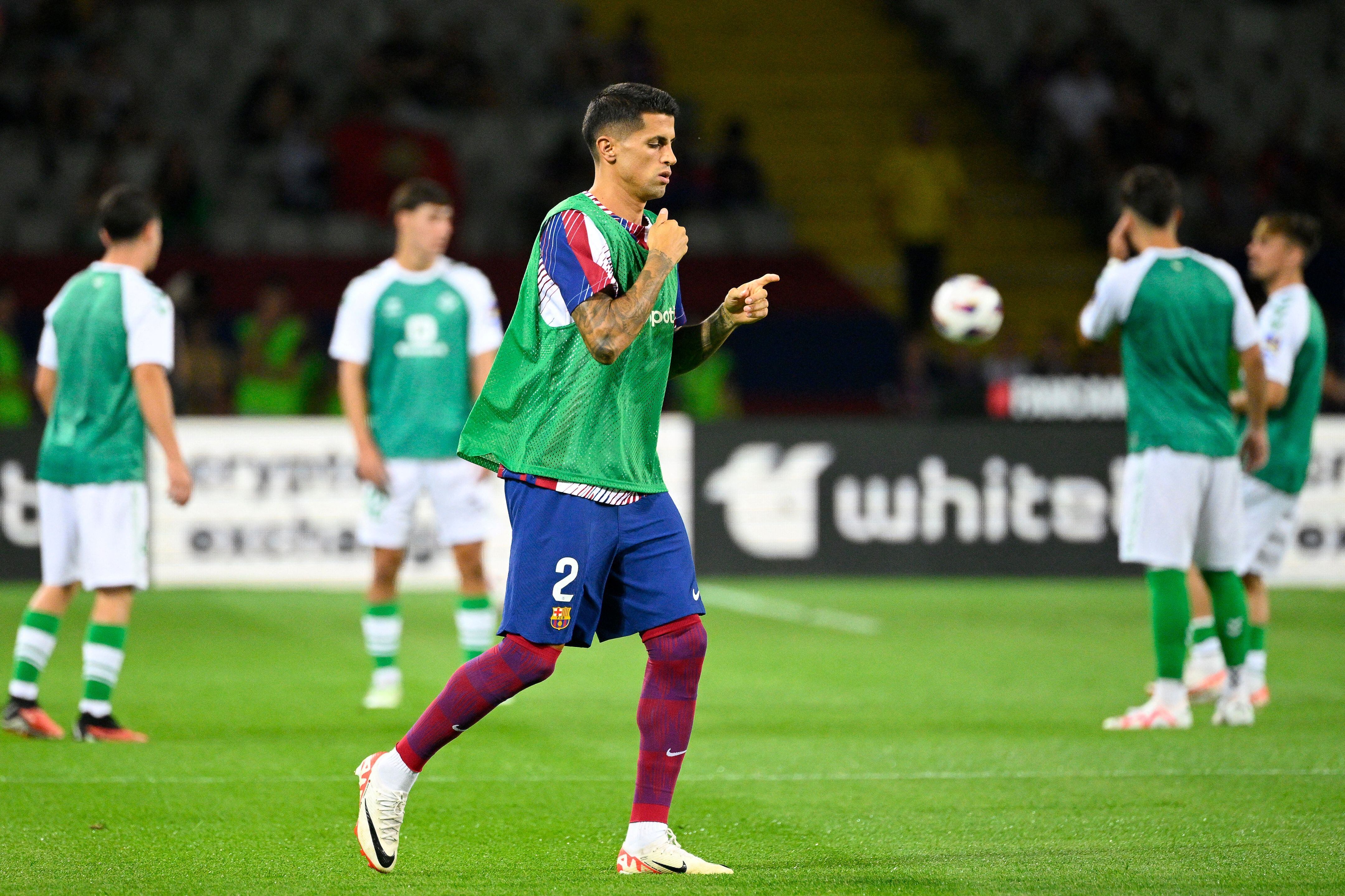 Barcelona&#039;s Portuguese defender #02 Joao Cancelo warms up before the start of the Spanish Liga football match between FC Barcelona and Real Betis at the Estadi Olimpic Lluis Companys in Barcelona on September 16, 2023. (Photo by Josep LAGO / AFP) (Photo by JOSEP LAGO/AFP via Getty Images)