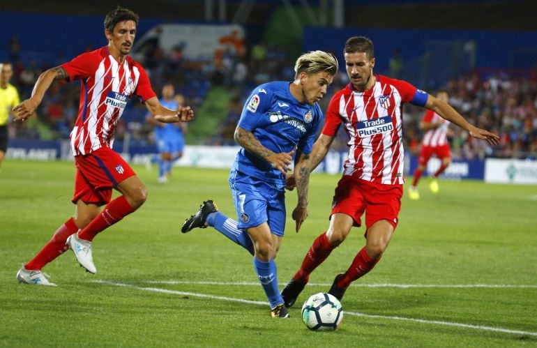 El capitán del Atlético de Madrid, Gabi Fernández, lucha el balón con Álvaro, del Getafe.