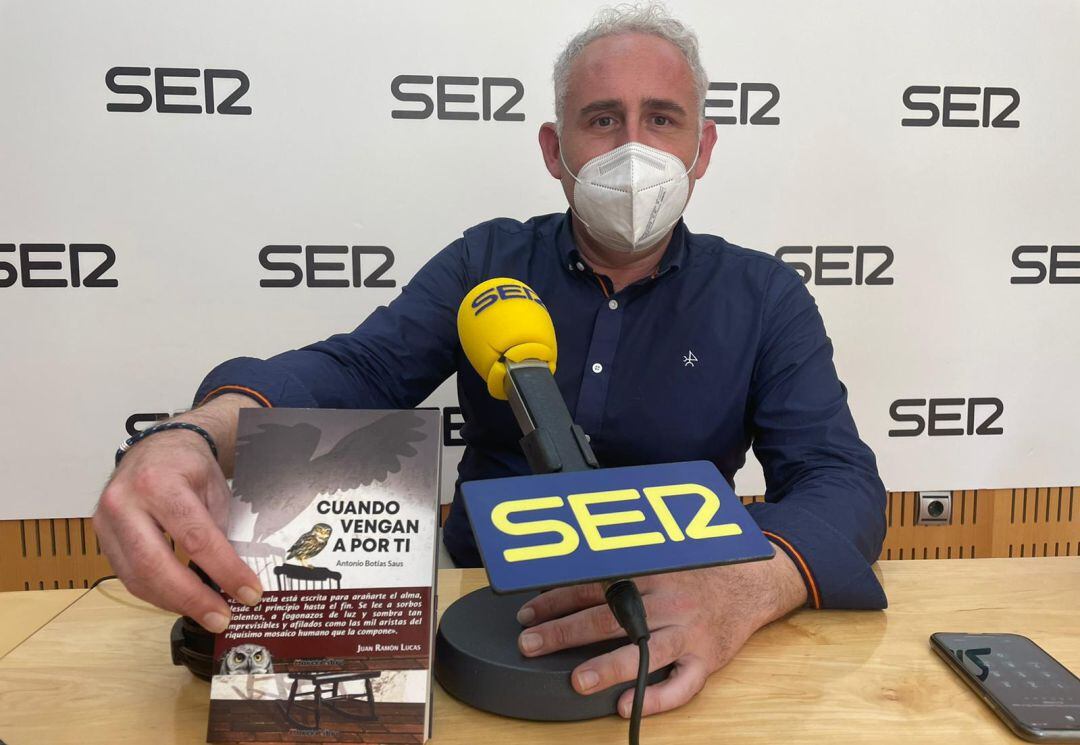 Antonio Botías en los estudios de Radio Murcia con un ejemplar de su primera novela: Cuando vengan a por ti