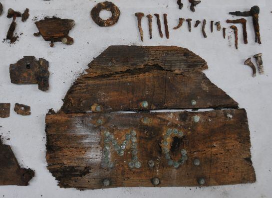 This handout picture released on January 26, 2014 by Sociedad de Ciencia Aranzadi shows corroded metal pieces, rotten wood fragments and a board with the initials MC that could help to confirm the final resting place of the autor of &quot;Don Quixote&quot; the late