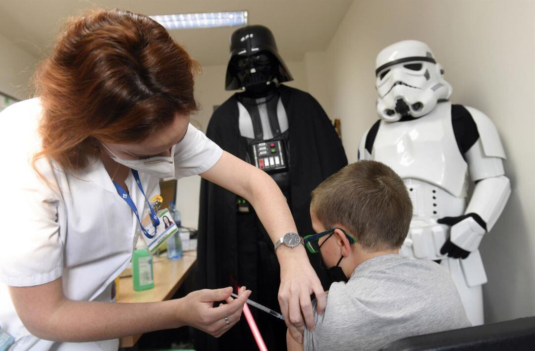 Un niño recibe la vacuna en Asturias acompañado de personajes de Star Wars.