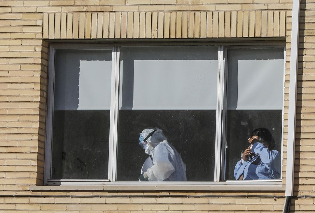 Un sanitario con un EPI y una enferma en el Hospital Antiguo de la Fe en Valencia