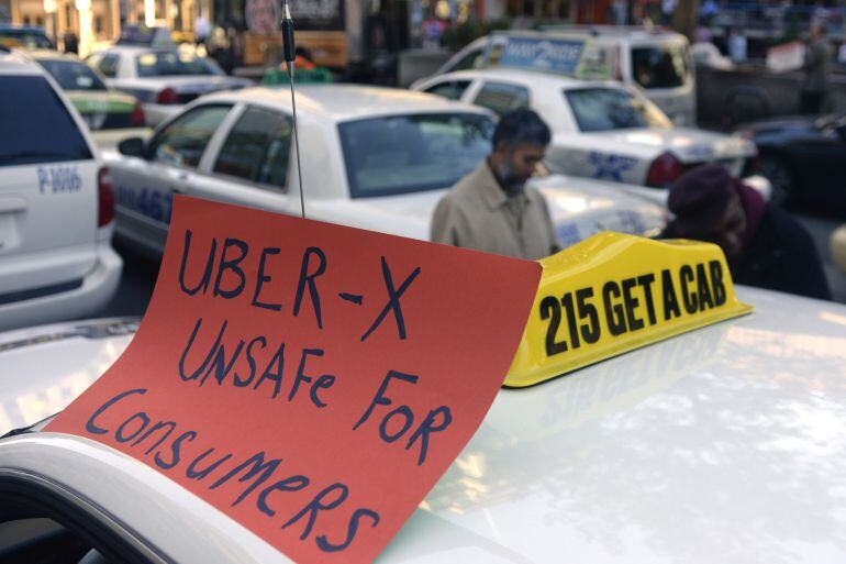 Drivers with the Taxi Workers Alliance of Pennsylvania protest on near Love Park in Philadelphia Oct. 8, 2014, as Uber and Lyft are making a concerted push to bring their ride-share services to Philadelphia. The state&#039;s Public Utility Commission is expect