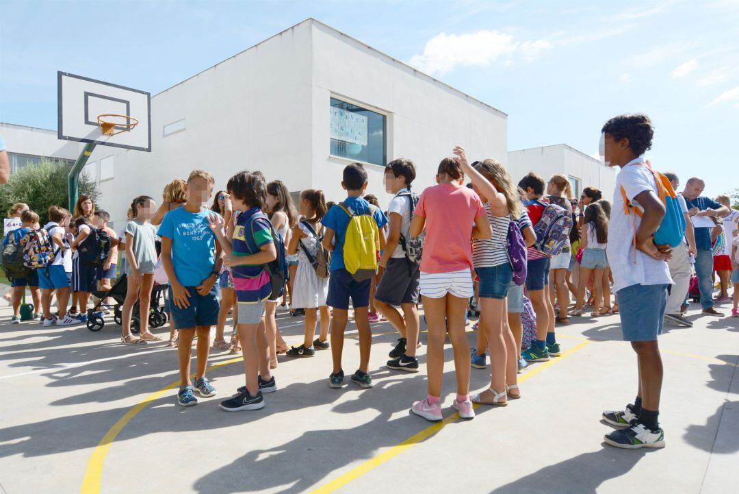 Alumnos de infantil y primaria esperan en el recreo del colegio