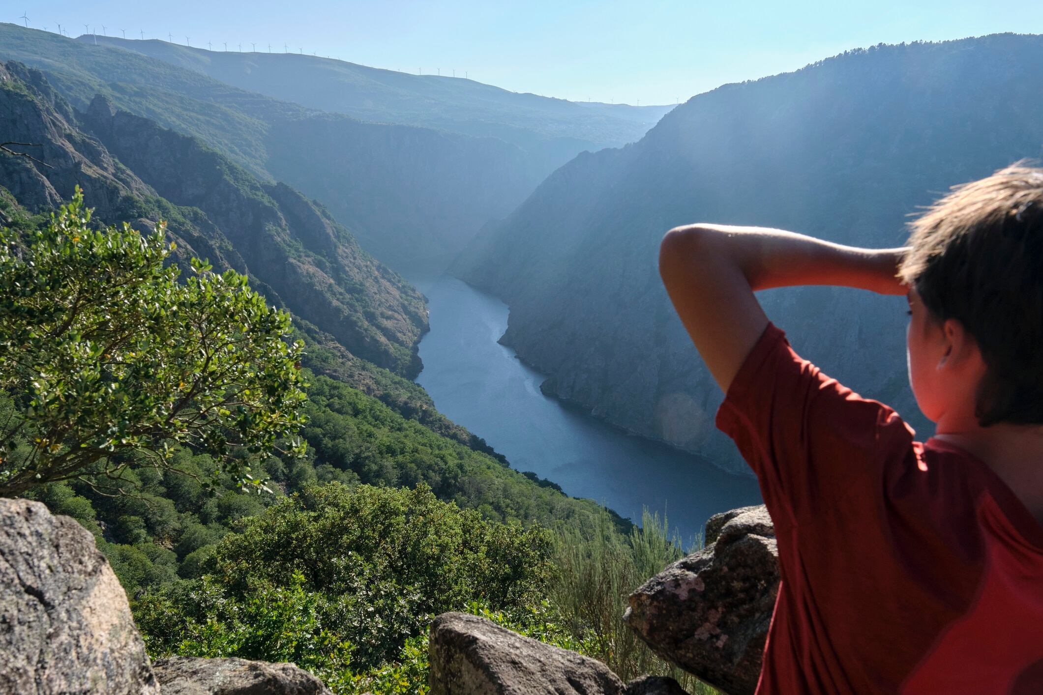 Boy looking at the river Sil from a natural viewpoint. Ribera Sacra, Galicia