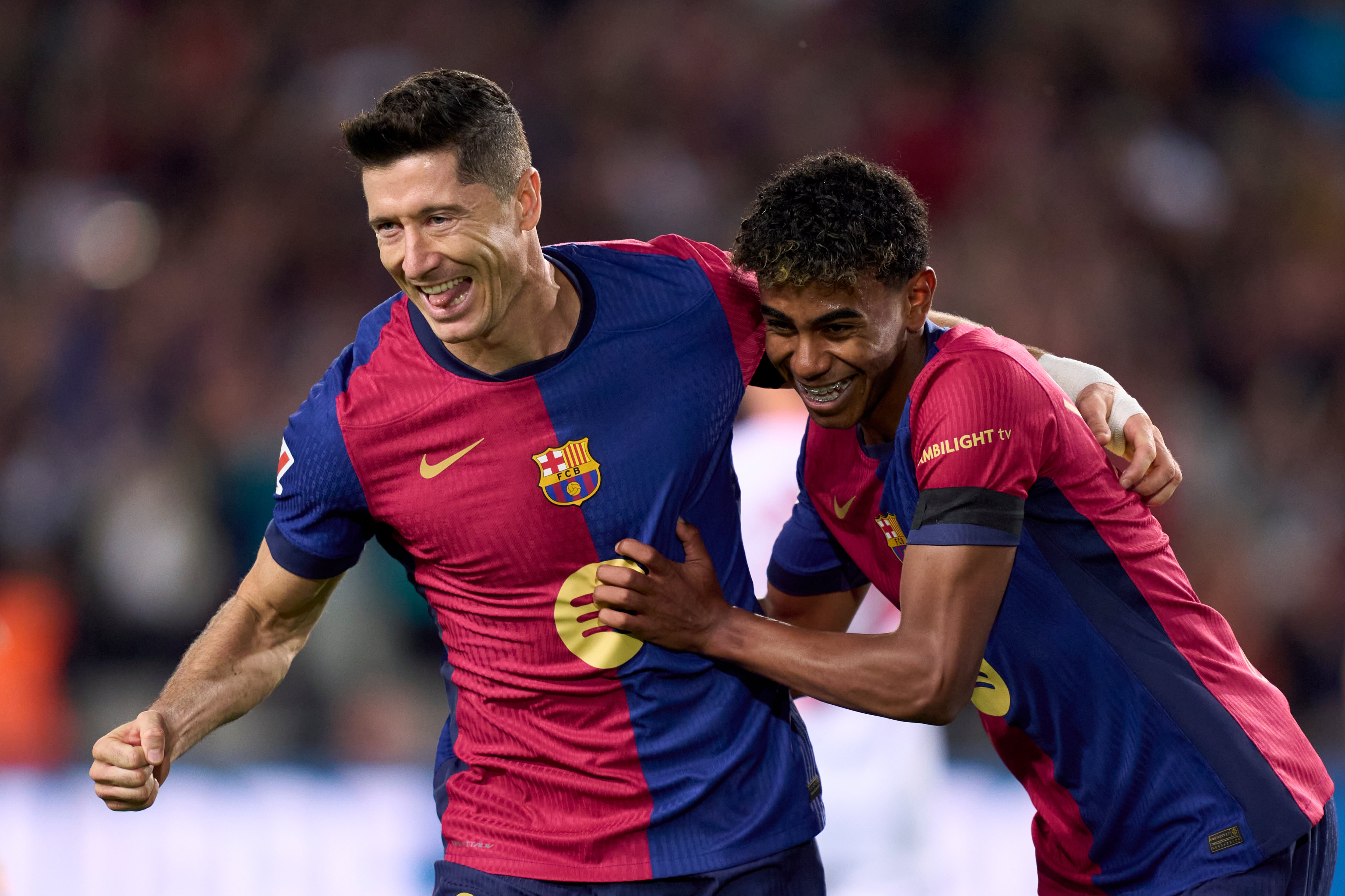 BARCELONA, SPAIN - OCTOBER 20: Robert Lewandowski of FC Barcelona celebrates with his teammate Lamine Yamal of FC Barcelona after scoring his team&#039;s first goal during the La Liga EA Sports match between FC Barcelona and Sevilla FC at Estadi Olimpic Lluis Companys on October 20, 2024 in Barcelona, Spain. (Photo by Pedro Salado/Getty Images)