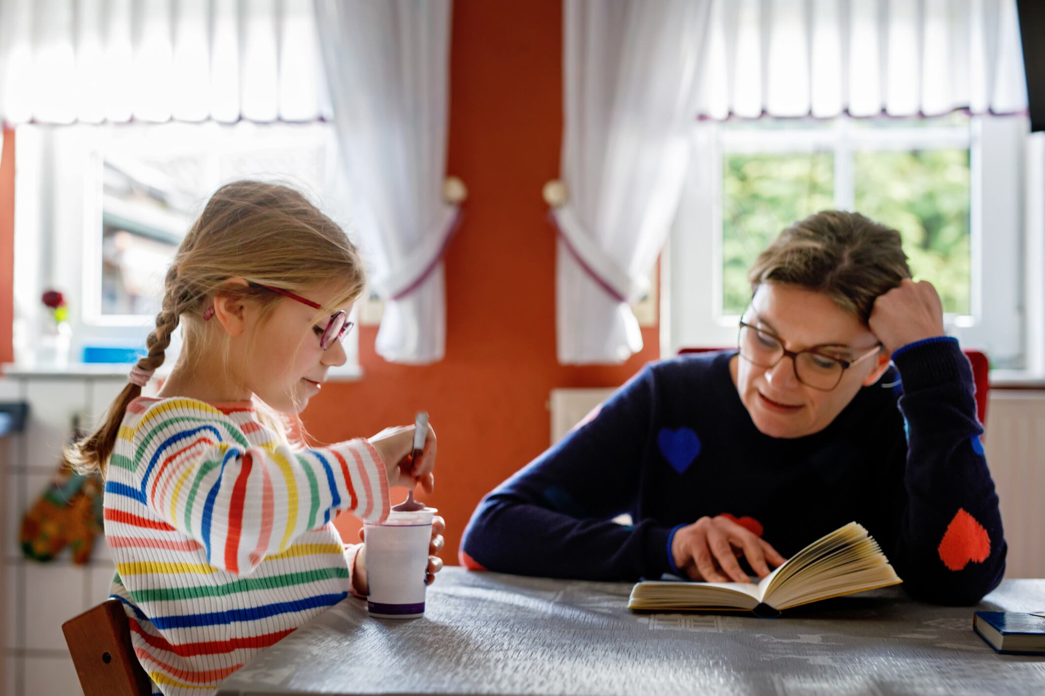 Mother reading a book for her little daughter. happy family time.