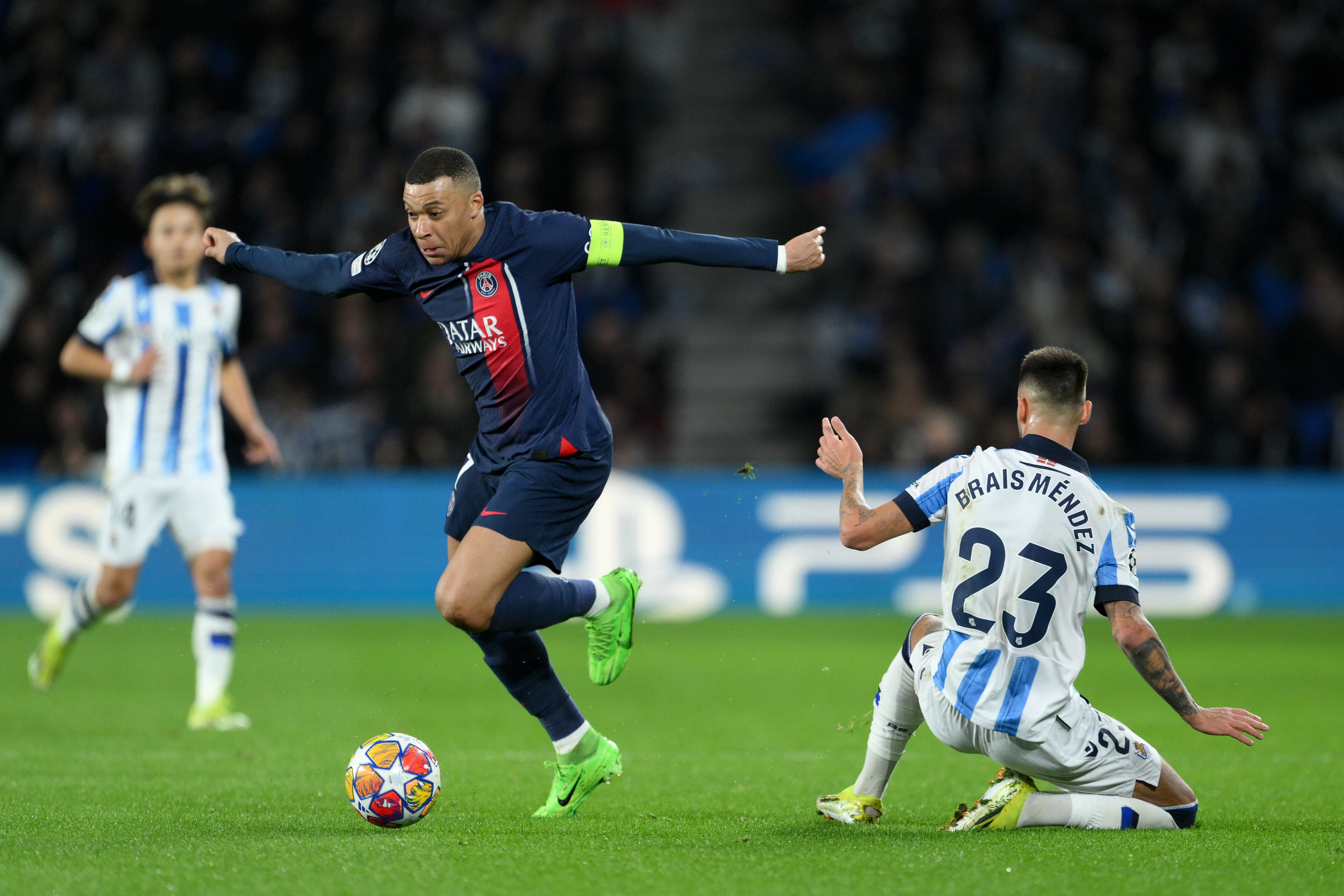 SAN SEBASTIAN, SPAIN - MARCH 05: Kylian Mbappe of Paris Saint-Germain runs with the ball past Brais Mendez of Real Sociedad during the UEFA Champions League 2023/24 round of 16 second leg match between Real Sociedad and Paris Saint-Germain at Reale Arena on March 05, 2024 in San Sebastian, Spain. (Photo by David Ramos/Getty Images)