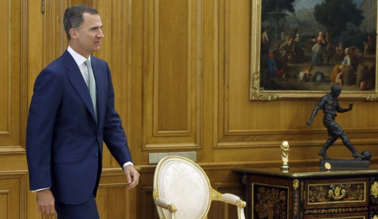 El rey Felipe VI recibe a sus invitados en una de las salas del Palacio de la Zarzuela.