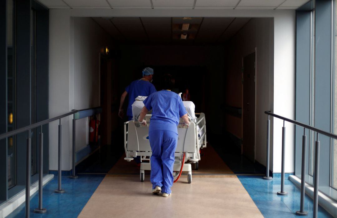 Medical staff transfer a patient through a corridor at The Royal Blackburn Teaching Hospital in East Lancashire, during the current coronavirus disease (COVID-19) epidemic, on May 14, 2020 in Blackburn, England. 