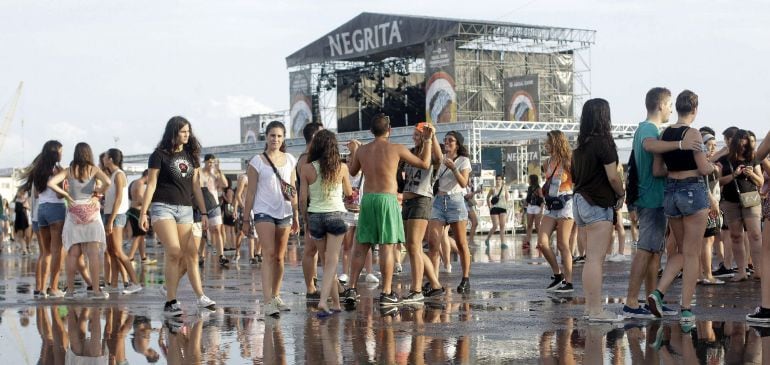 Varias jóvenes tras la tormenta registrada en la primera jornada grande del festival Arenal Sound