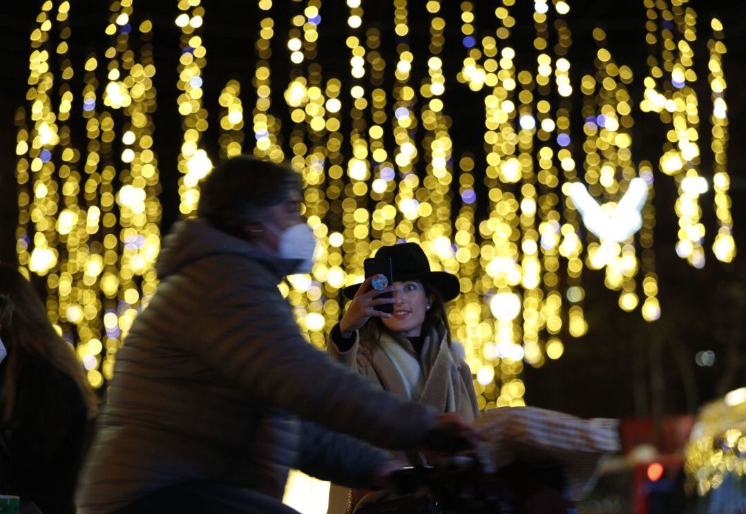 Una persona se fotografía con las luces de Navidad 