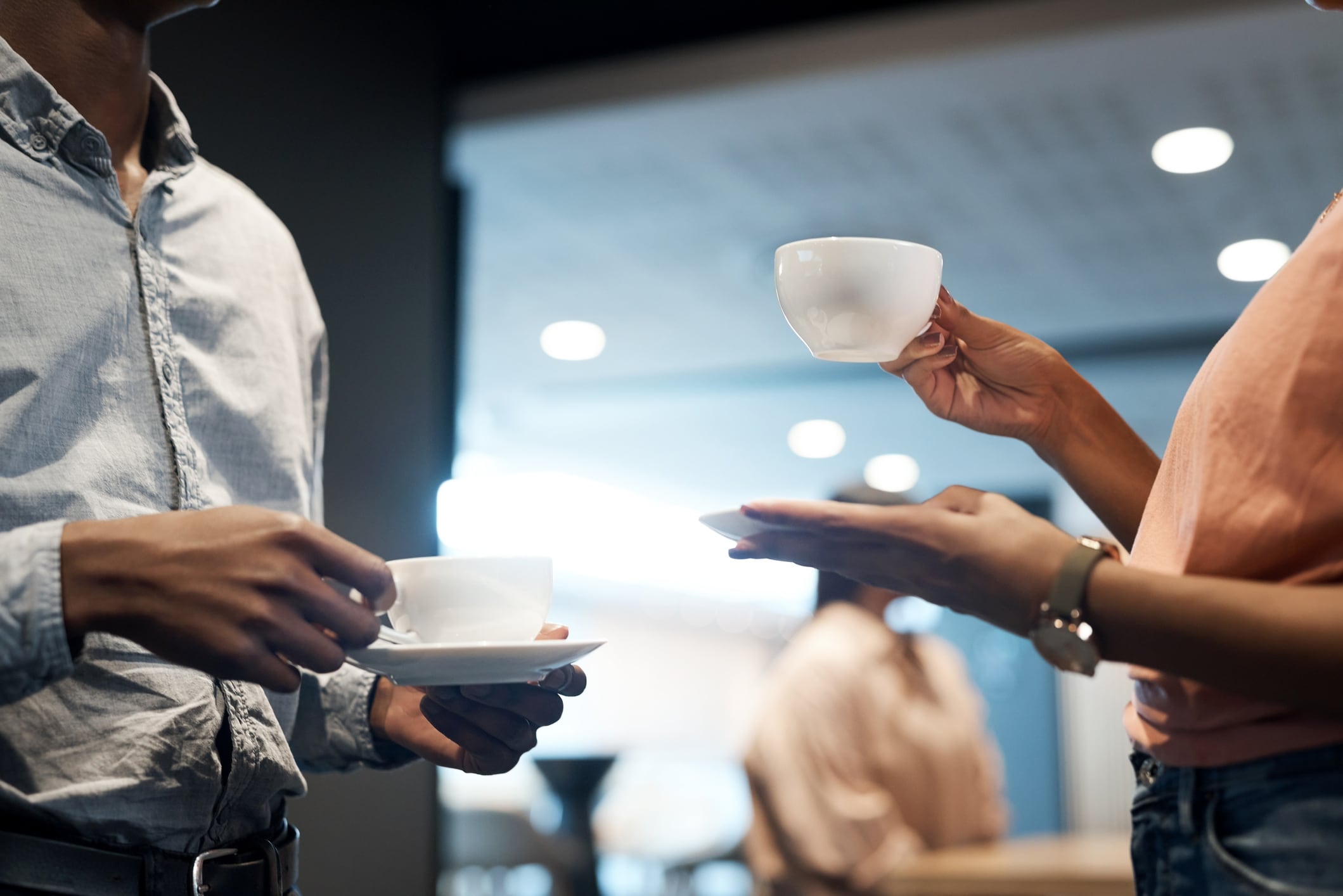 Dos compañeros de trabajo toman café durante su jornada laboral.