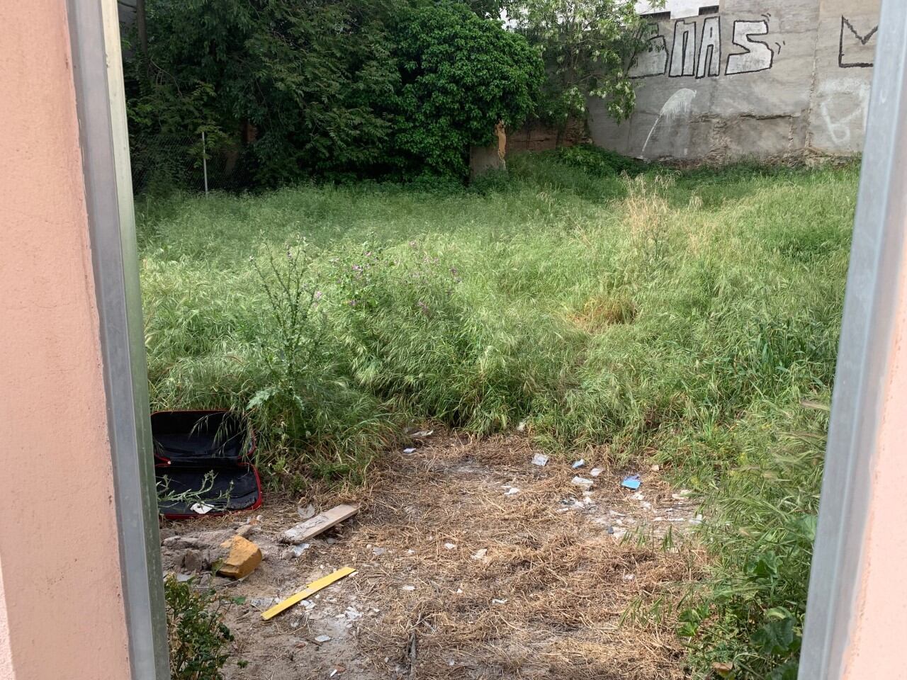 Solares en la Plaza Moreno, con puertas abiertas y llenos de basura y maleza