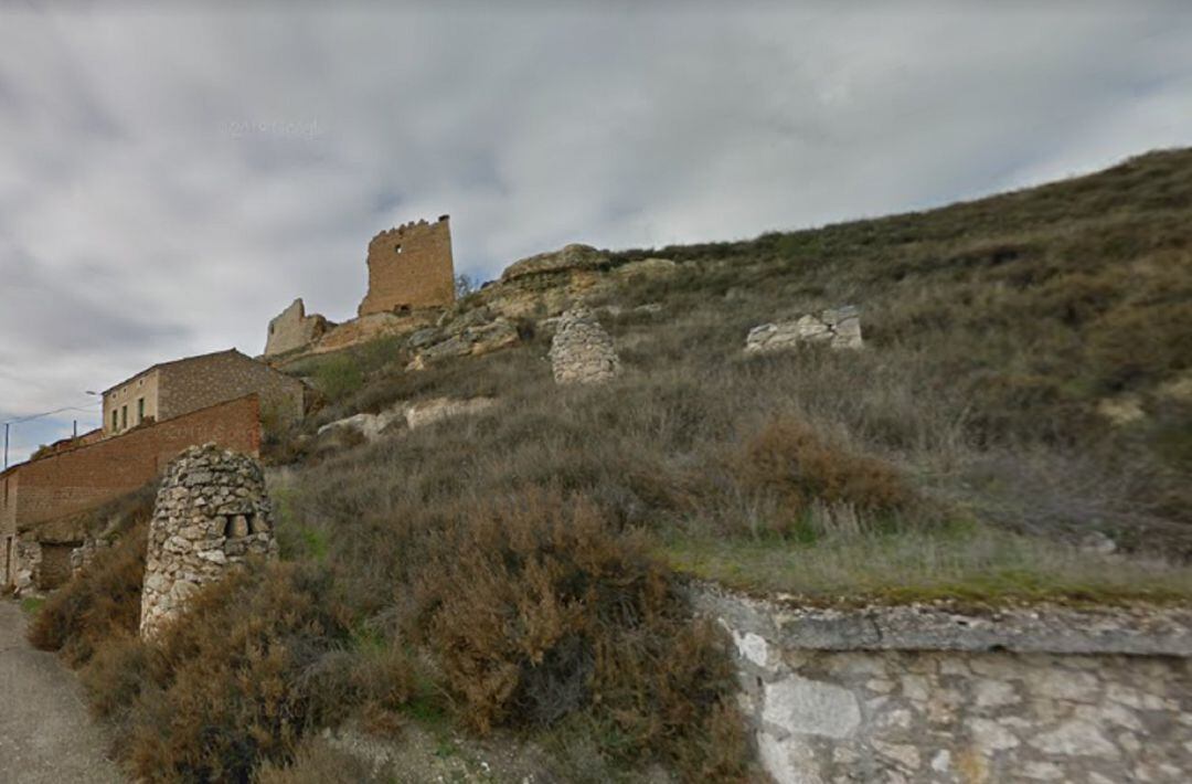 Imagen de las bodegas de Torregalindo con las ruinas del castillo al fondo