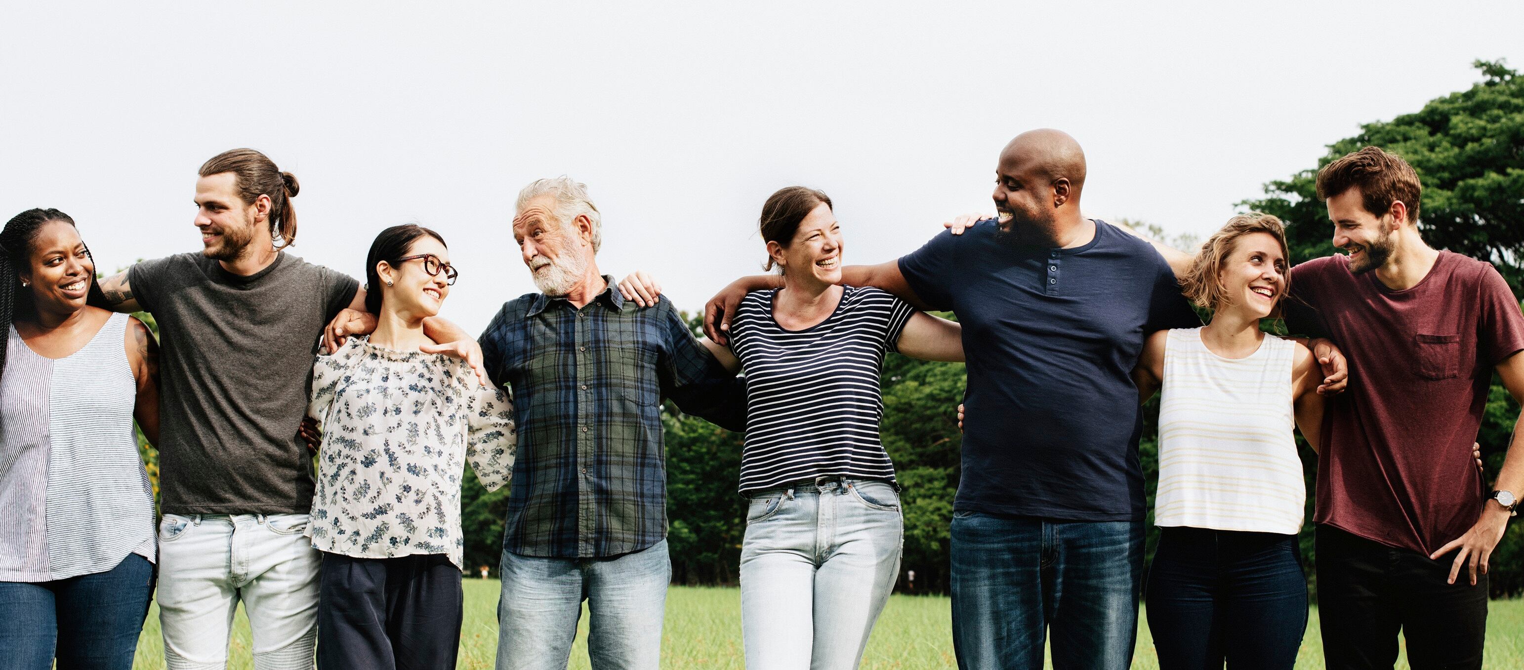 Group of people hugging each other in the park