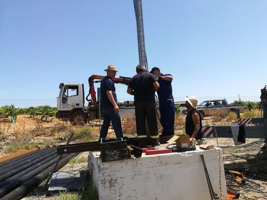 Operarios trabajando en el arreglo de la bomba de extracción del agua.