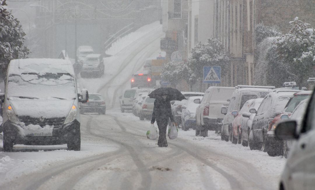 Un hombre camina en medio de una gran nevada en Becerrea, en Lugo, Galicia.