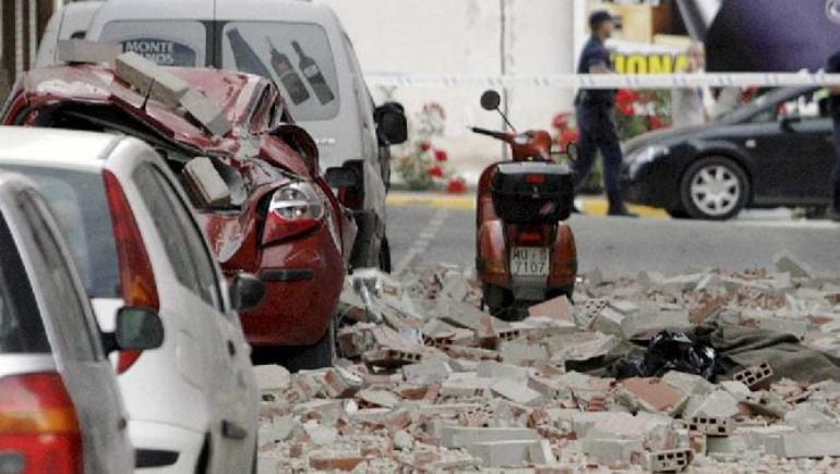 Una calle y algunos vehículos destrozados tras el seísmo en la localidad murciana de Lorca.