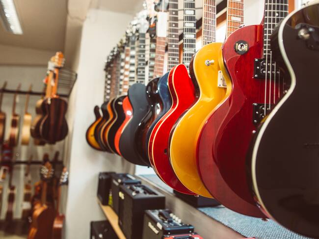 Close up of electric guitars in a row in huge instrument shop