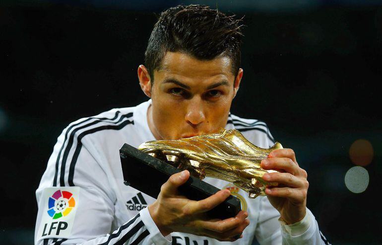 Cristiano Ronaldo besa la &#039;Bota de Oro&#039; concedida por la temporada 2013-2014. En la presente, está mejorando sus cifras goleadoras.